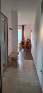 a living room with a table and a bench at House Baglija in Lumbarda