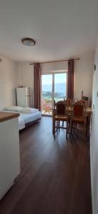 a bedroom with a bed and a table and chairs at House Baglija in Lumbarda