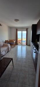 a kitchen and living room with a view of the ocean at House Baglija in Lumbarda