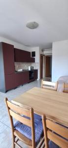 a kitchen with a wooden table and two chairs at House Baglija in Lumbarda