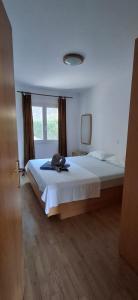a bedroom with a bed with a hat on it at House Baglija in Lumbarda
