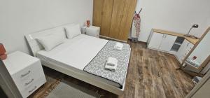a small bedroom with a bed with a phone on it at Valletta Stylish City Pad in Valletta