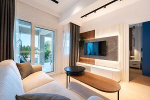 a living room with a couch and a tv at Elysium Tivat in Tivat