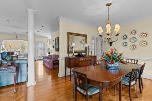 a dining room and living room with a table and chairs at Lake Escape - Lake Waccamaw home in Lake Waccamaw
