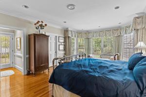 a bedroom with a bed with a blue comforter at Lake Escape - Lake Waccamaw home in Lake Waccamaw