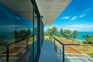 a view of the ocean from the balcony of a house at Tahiana Villa in Haad Tian