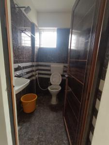 a small bathroom with a toilet and a sink at Hotel in Bengaluru
