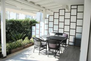 a patio with a black table and chairs on it at Super Leisure Vila-Plazhi San Pietro, Gjiri i Lalezit in Lalzit Bay