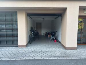 an open garage with bikes parked in a building at Apartmán Lesněnka in Říčky