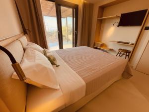 a hotel room with a bed and a window at Spitaki Among Olives in Tsoukalades +31 photos