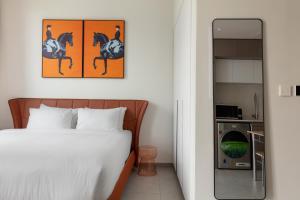 a bedroom with a bed and a mirror at Sahab - Hermes Leather Home in Sharjah