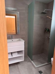 a bathroom with a sink and a shower at House of Harmony Standaard studio Mira ADULTS ONLY in Achlada