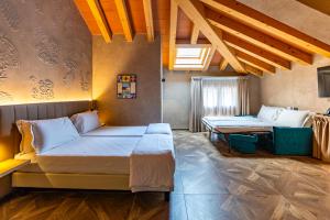 a bedroom with two beds in a room at Parc Hotel San Pietro in Spiazzi Di Caprino +42 photos