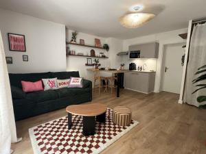 ein Wohnzimmer mit Sofa und Tisch in der Unterkunft Appartement chic & cosy au calme in Albi