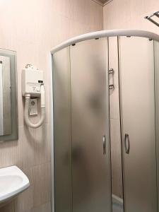 a shower with a glass door in a bathroom at Nana's Mini Hotel in Tbilisi City