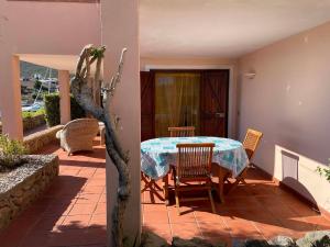 a house with a table and chairs on a patio at Sardegna Beach Cala Reale in Santa Marinella