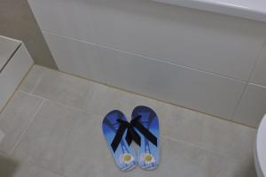 un paio di scarpe sul pavimento di un bagno di Inselblume 58 - Ferienwohnung mit Balkon in Neue Tiefe a Neue Tiefe Fehmarn Altre 16 foto