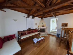 a living room with a couch and a fireplace at Klea's House Skopelos in Skopelos Town