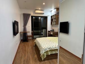 a bedroom with a bed and a mirror at An Lạc 402MD in Hanoi
