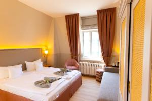 Postel nebo postele na pokoji v ubytování Hotel Germania