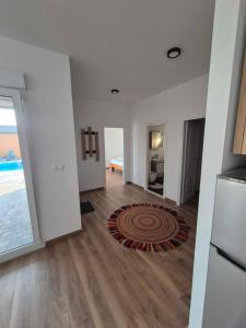 a living room with white walls and a wooden floor at bb resorts in Kosor