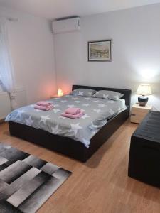 a bedroom with a bed with two pink towels on it at Villa Elma in Sarajevo +53 photos