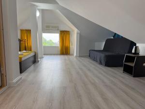 a large white room with a bed and a window at Complex Marinn Costinesti in Costinesti