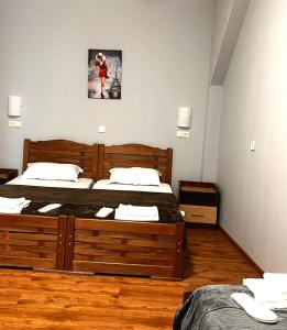 a bedroom with two beds and a picture on the wall at Nana's Mini Hotel in Tbilisi City +6 photos