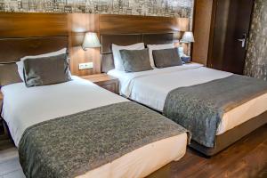 Postel nebo postele na pokoji v ubytování Ma City Hotel