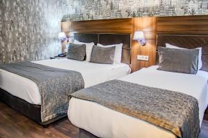 Postel nebo postele na pokoji v ubytování Ma City Hotel