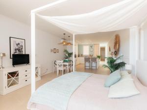 a white bedroom with a large bed and a living room at Marsalada 2 - Apartment with sea view in Playa de Mar