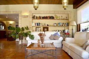 a living room with a white couch and a coffee table at Hotel La Gastrocasa - Adults Only in Gandía