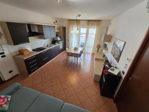a kitchen and living room with a couch and a table at Aurora's Home in Dalmine