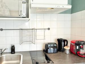 a kitchen counter with a sink and a microwave at Studio clair rivage centre-ville in Lorient +9 photos