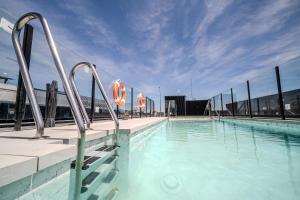 a swimming pool with metal bars on a building at ITC Madrid by Soho Boutique in Madrid