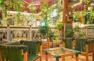 a restaurant with a table and chairs and plants at Nestay in Karnāla
