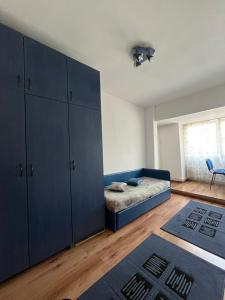 1 dormitorio con 1 cama y armario azul en Cazare festival Untold, en Văleni