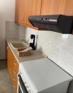 a kitchen counter with a stove and a sink at Melivia apartments (2) in Ierissos +5 photos