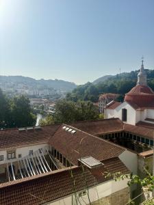 arial view of a building with roofs and a tower at Amadeo Art&Stay Apartments in Amarante