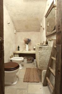 a bathroom with a toilet and a sink at Casa Nachiro - 16th Century Oil Mill Historic Dimora in Nardò +27 photos