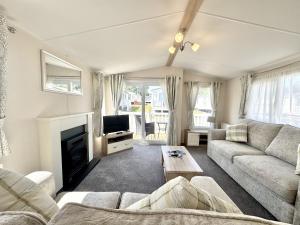 a living room with a couch and a tv at North Bay Leisure Park in Bridlington