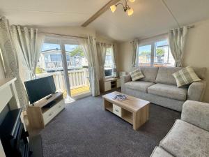 a living room with a couch and a tv at North Bay Leisure Park in Bridlington