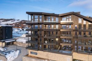 an architectural rendering of a apartment building with snow at Riddertunets luksuriøse in Beitostøl