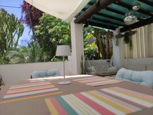 a table with a lamp on top of a patio at Ku terraza PARKING in Murcia