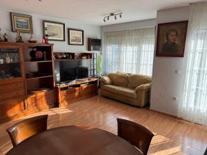 a living room with a couch and a table at Casa el Mirador in Maliaño