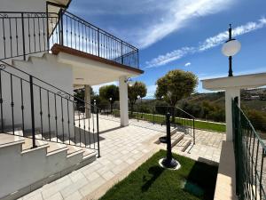 a staircase leading to a house with a balcony at Dimora i Mandorli 1 in Colonnella