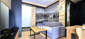 a living room with a couch and a table at VIP Apartamenty Centrum2 in Zakopane