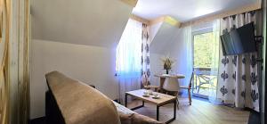 a living room with a couch and a window at VIP Apartamenty Centrum2 in Zakopane