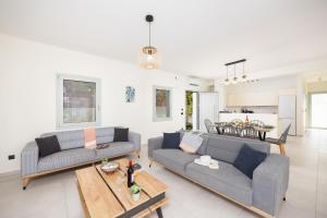 a living room with two couches and a table at Villa Kira in Trapezaki