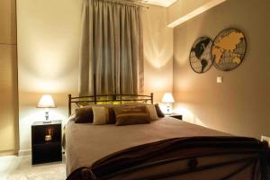 a bedroom with a bed with two lamps and a window at Sparta View Apartments Armonias Boutique B2 in Sparti